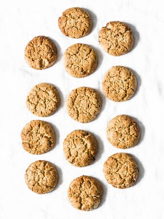 Delicious oatmeal gluten free cookies with walnuts on a light background, top viewの写真素材