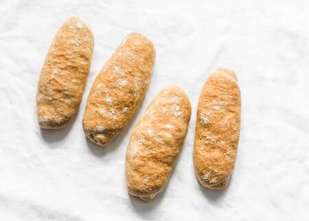 Homemade whole grain hot dogs buns on a light background, top viewの写真素材