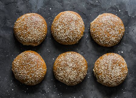Homemade whole wheat hamburger rolls on a dark background, top viewの写真素材