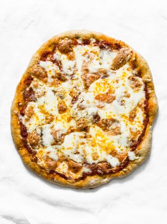 Whole grain  salami sausage, mozzarella, tomato pizza on a light background, top viewの写真素材