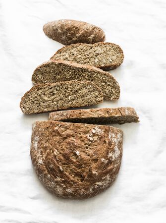 Slices of gluten-free homemade bread on a light background, top view. Healthy food diet conceptの写真素材