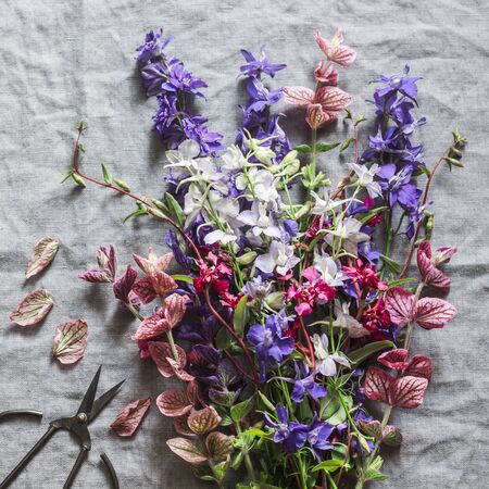 Wild flowers garden rustic bouquet and vintage scissors on gray  background, top view. Vintage styleの写真素材
