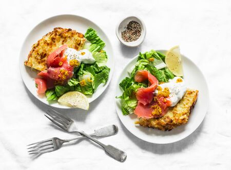 Potato tortilla with greek yogurt, smoked salmon and green salad on a light background, top view. Delicious breakfast, appetizer, tapasの写真素材
