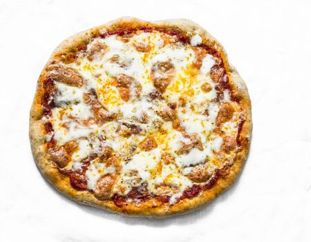 Salami sausage, mozzarella, tomato pizza on a light background, top viewの写真素材
