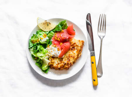 Spanish potato tortilla with greek yogurt, smoked salmon and green salad on a light background, top viewの写真素材