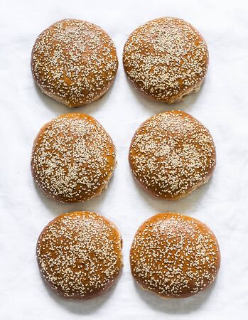 Homemade whole wheat hamburger buns on a light background, top viewの写真素材