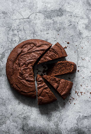 Simple chocolate brownie cake on a grey background, top view