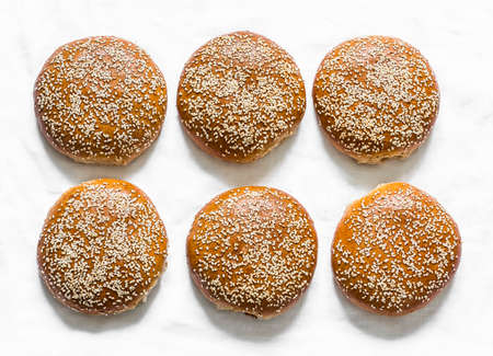 Homemade whole wheat hamburger rolls on a light background, top viewの写真素材
