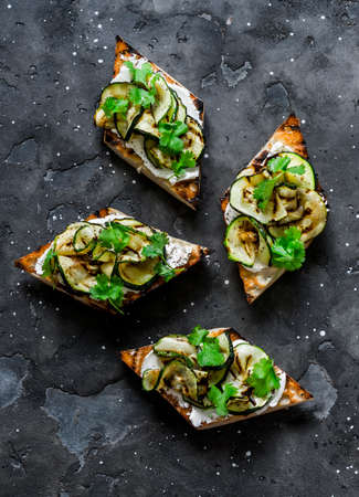 Grilled zucchini and cream cheese sandwiches on a gray background, top view. Delicious tapas, appetizer, snackの写真素材