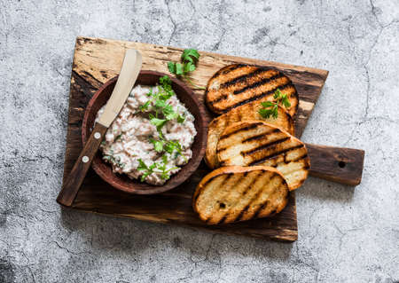 Canned tuna, cream cheese, herb pate and grilled bread on a cutting Board, top view. Delicious tapas, appetizer, snackの写真素材