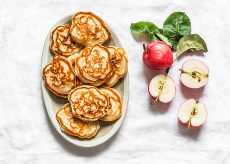Apple pancakes on a light background, top view. Delicious breakfast, dessert, snackの写真素材