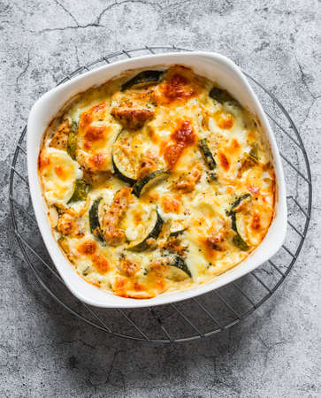 Zucchini, chicken, mozzarella cheese baked casserole on a gray background, top view. Delicious lunchの写真素材