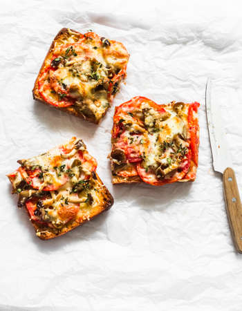 Delicious breakfast. Hot sandwiches with mushrooms, tomatoes, mozzarella, thyme on a light background, top viewの写真素材