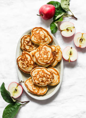 Apple pancakes on a light background, top view. Delicious breakfast, dessert, snackの写真素材