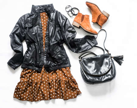 Polka dot brown dress, windbreaker jacket, bag and chelsea shoes on a light background, top view. Women's clothing fashion. Flat layの写真素材