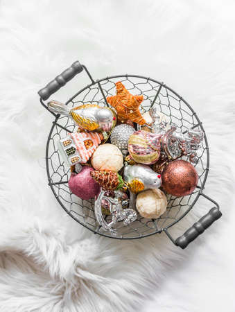 Vintage Christmas toys in a metal basket on a fluffy carpetの写真素材
