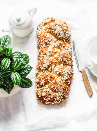 Homemade freshly baked hala on a light background, top view