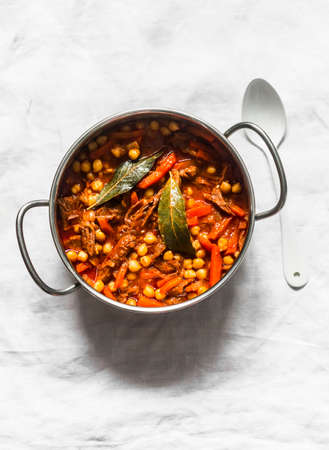 Beef stew with chickpeas in a pot on a light background, top viewの写真素材