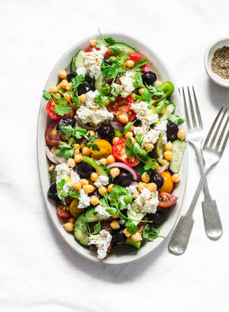 Greek chickpeas salad on light background, top view. Vegetarian healthy diet food