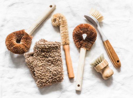 Natural brushes for cleaning the kitchen, washing dishes in scandinavian style on a light...