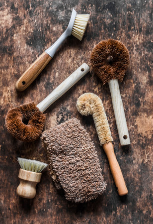 Natural brushes for cleaning the kitchen, washing dishes in scandinavian style on a wooden background, top viewの写真素材