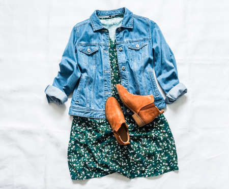 Women's clothing for spring, summer, autumn - denim jacket oversize, floral dress, suede chelsea boots on a light background, top viewの写真素材