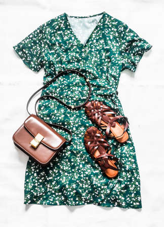 Floral print green dress, leather roman sandals and cross body bag - women's summer clothing conceptの写真素材