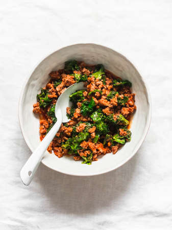 Bolognese sauce with kale on a light background, top viewの写真素材