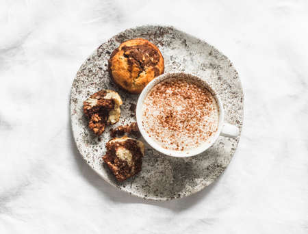 Banana chocolate cakes and cappuccino on a light background, top view. Delicious dessert, breakfastの写真素材