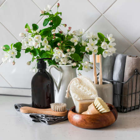 Bathroom skin care still life. Shampoo, brushes, soap, towels on a light background