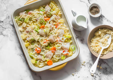Cooking savory cod and leek crumble - delicious lunch on a light background, top viewの写真素材