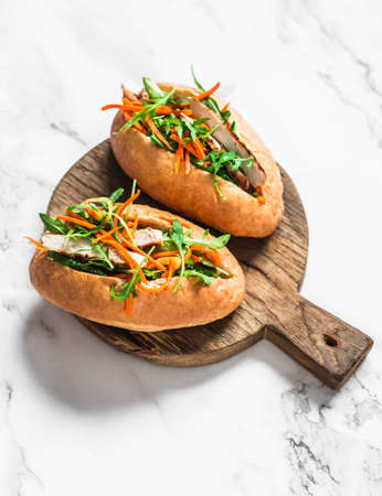 Pork Banh Mi hot dogs on cutting board on a light background, top viewの写真素材