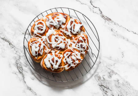 Cinnamon rolls - delicious dessert on a light background, top viewの写真素材