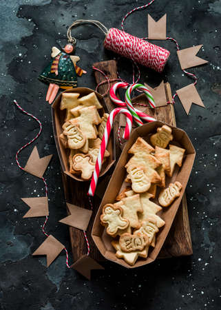Homemade Christmas shortbread cookies. Edible Christmas gift on a dark background, top view