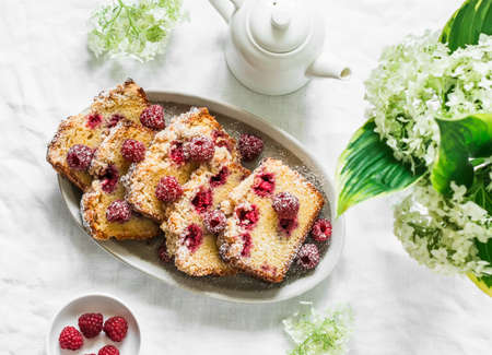 Traditional pound cake recipe with raspberries on a light background, top viewの写真素材