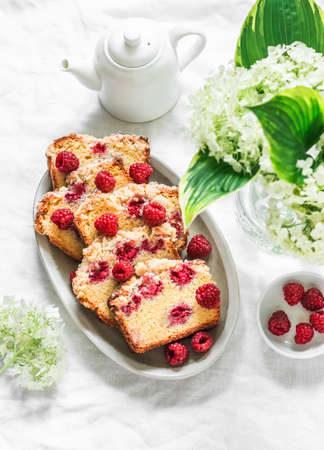 Traditional pound cake recipe with raspberries on a light background, top viewの写真素材