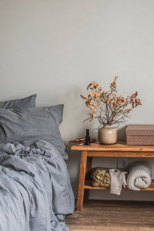 Bedroom interior - bed, bench with autumn decor. Cozy Scandinavian style interiorの写真素材