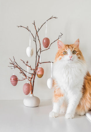 Beautiful ginger cat and easter bouquet decor on the table in the living room