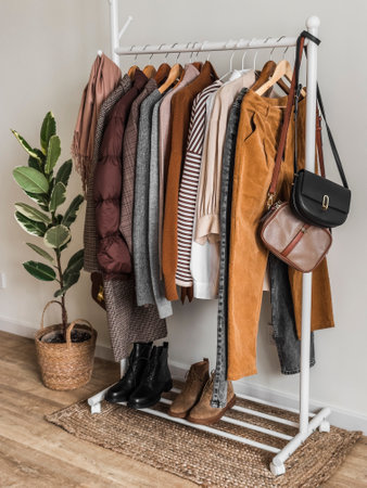 A set of autumn women's clothing on a floor hangerの写真素材