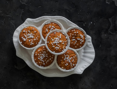 Almond flour muffins on a plate on a dark background, top viewの写真素材