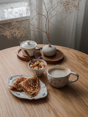 Cozy morning - breakfast, brunch on a wooden table - crepes, yogurt with granola and apple,...