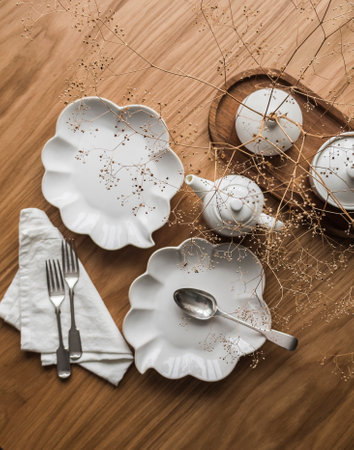 Tea time. Beautiful dishes on a wooden table - dessert plates, cutlery, teapot, top view.