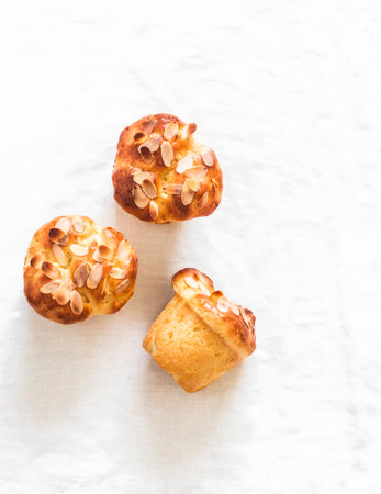 Fresh pastries - brioche buns on a light background, top viewの写真素材