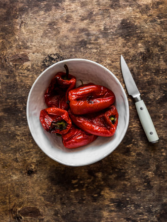 Baked sweet pepper in a bowl on a wooden background. Ingredients for bruschetta, sandwiches, tapasの写真素材
