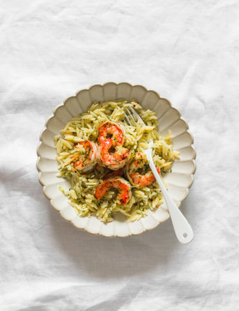 Orzo pasta with shrimp in dill-mustard-lemon marinade on a light surface, top viewの写真素材