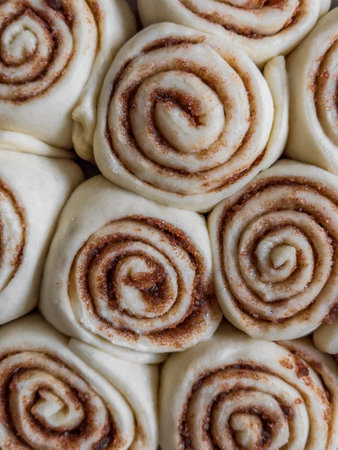 Raw cinnamon buns close-up. food backgroundの写真素材
