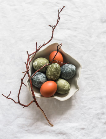 Easter eggs painted in natural shades on a light backgroundの写真素材
