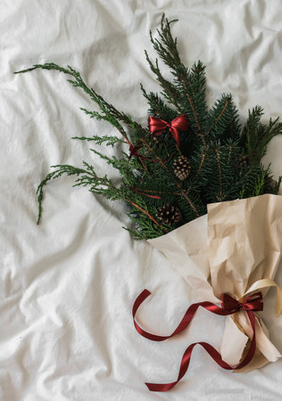 Christmas bouquet in craft paper with satin ribbons on a light background, top viewの写真素材