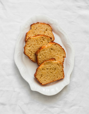 Slices of ricotta lemon cake on a white plate on a light background