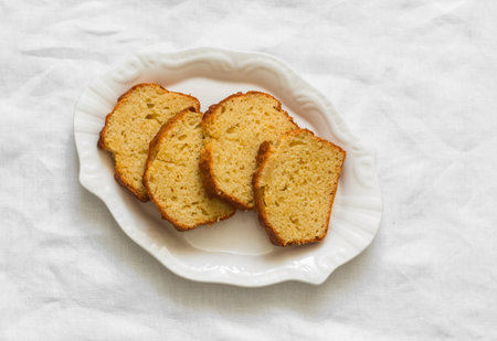 Slices of cake on a white plate on a light backgroundの写真素材